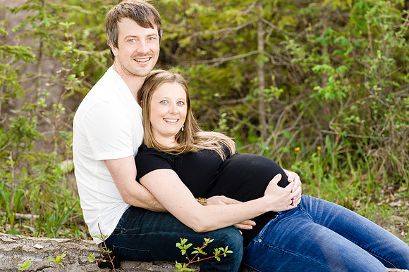 Maternity photo of married couple, holding pregnant belly