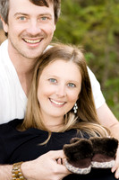 Pregnancy photoshoot of married couple  holding their newborn shoes