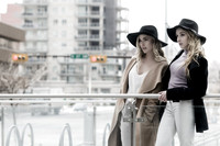 2 blonde fashionable women model in the city with black hats