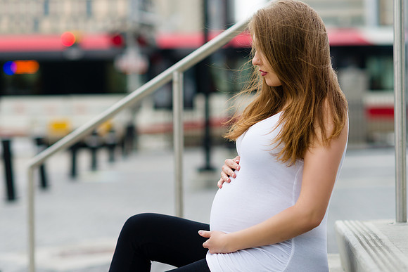 Pregnant Viktoriya with the C-Train in the background