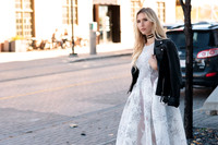 Jewelry Commercial Photo shoot, with blond woman Model wearing a long light blue overcoat, silk white dress, and Made by Jemily choker