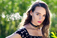 Woman model portrait in the forest with black choker and dress