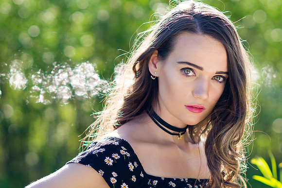 Woman model portrait in the forest with black choker and dress