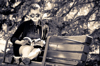 Business Woman reading a book on a bench
